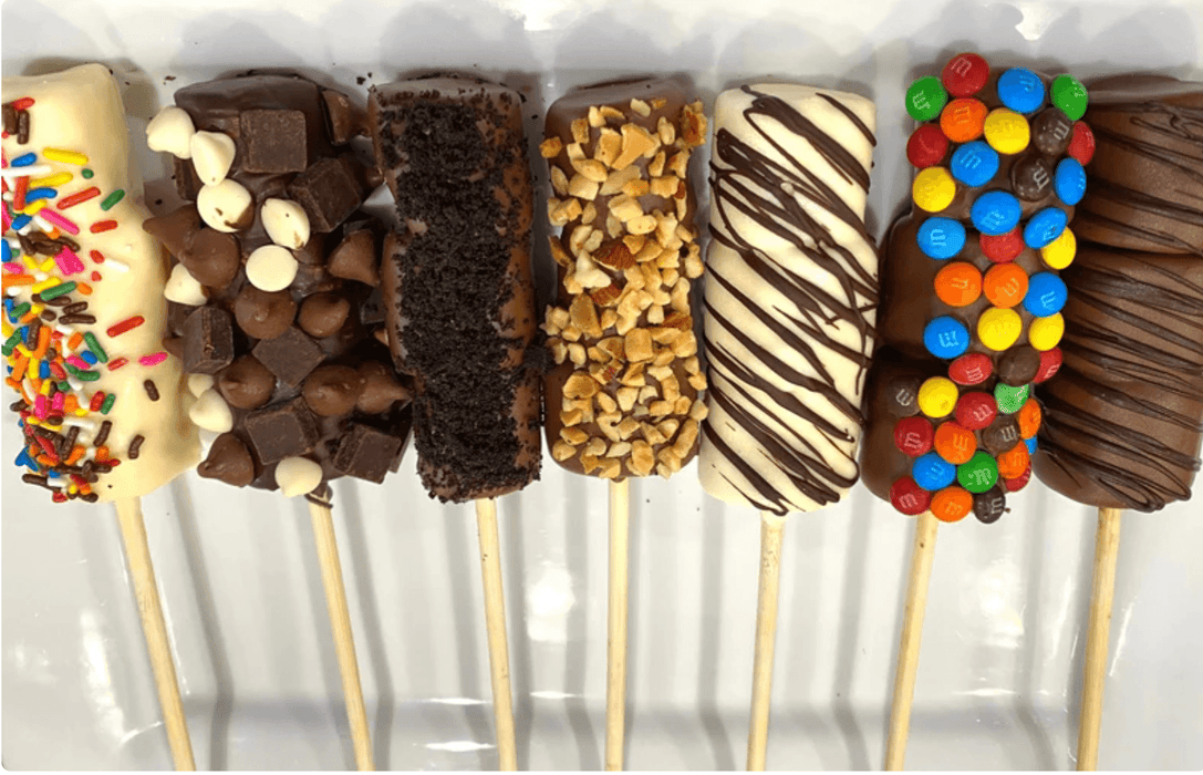 Assorted Chocolate Covered Marshmallow Pops with toppings like M&Ms, nuts, and chocolate drizzle, perfect for Purim gift baskets.