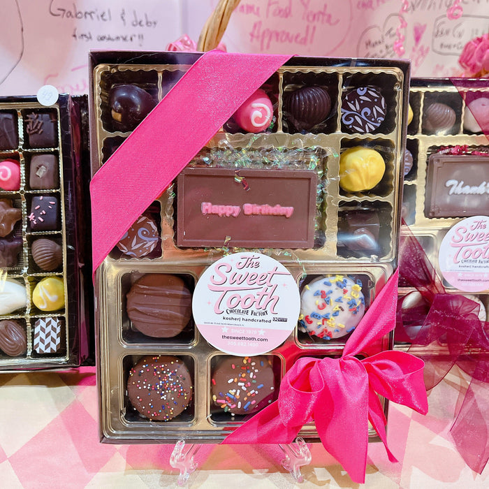 Say It With Chocolate birthday gift box featuring assorted truffles and a custom 'Happy Birthday' chocolate plaque with pink ribbon.