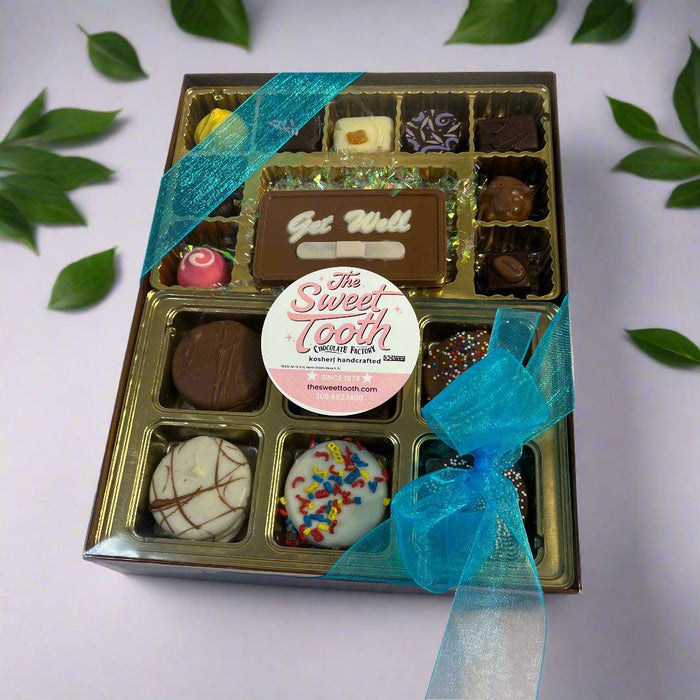 Get Well Say It With Chocolate gift box with assorted truffles, blue ribbon, and personalized chocolate message plaque.