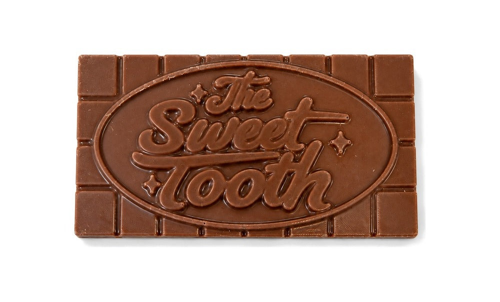 A milk chocolate bar with The Sweet Tooth logo on it