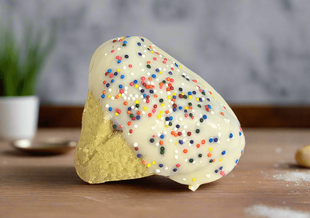 Close-up of white chocolate-dipped hamantaschen with rainbow sprinkles, featured in Small Purim Basket for festive Purim gifting.