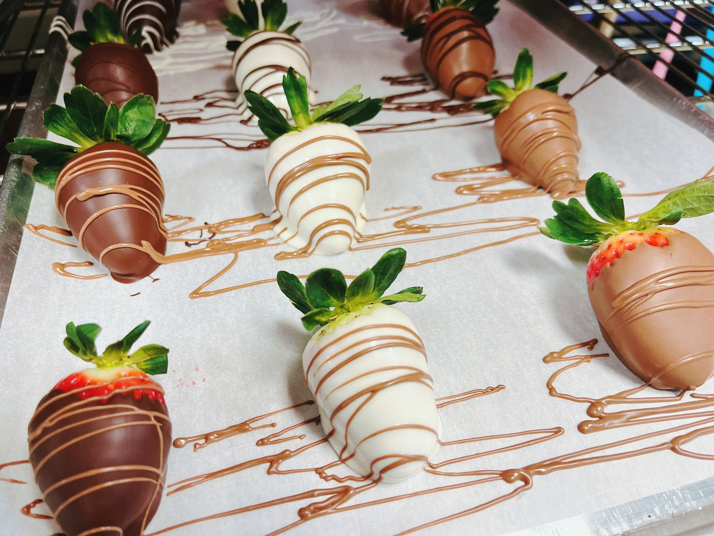 Assorted chocolate-dipped strawberries with decorative drizzle, part of The Ultimate Valentine’s Day Bundle gift collection.