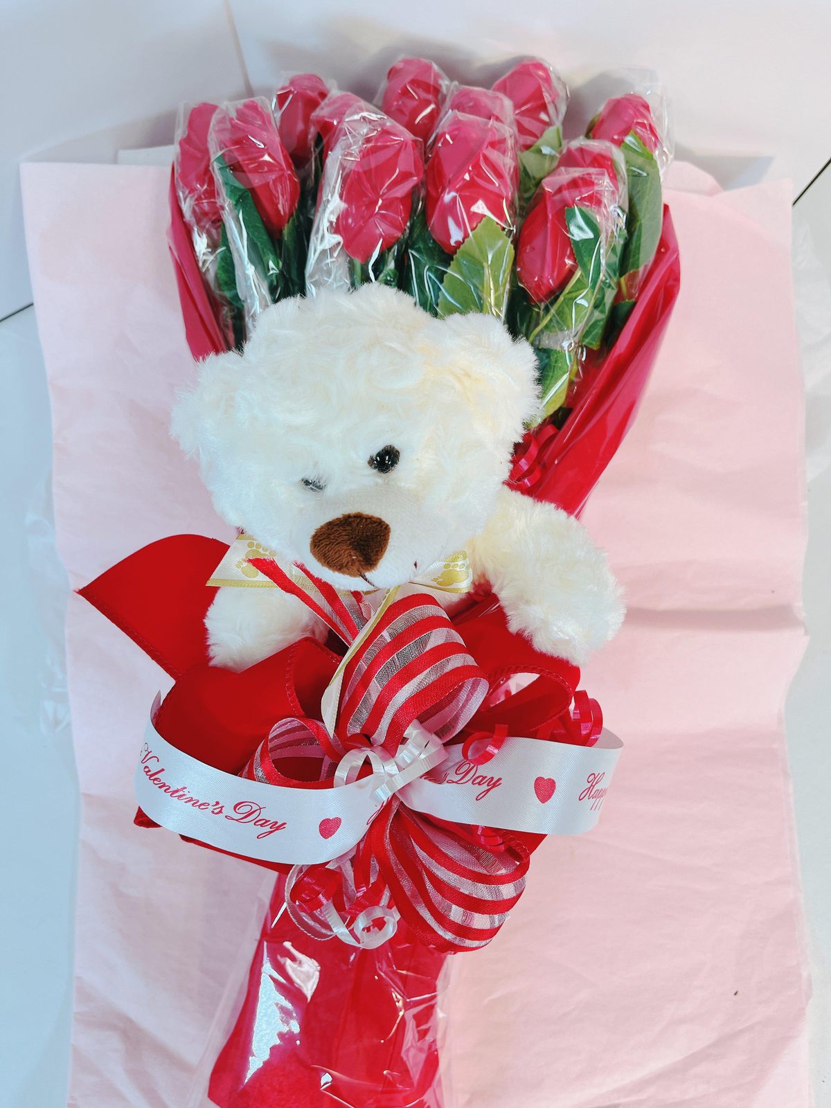Valentine’s bouquet with red chocolate roses and white teddy bear, included in The Ultimate Valentine’s Day Bundle.