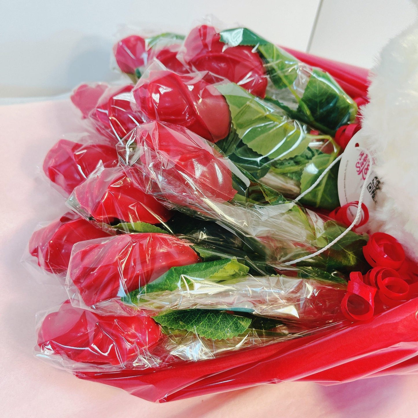 Wrapped red chocolate roses arranged in a bouquet, designed for Valentine's Day or themed party decorations and gifts.