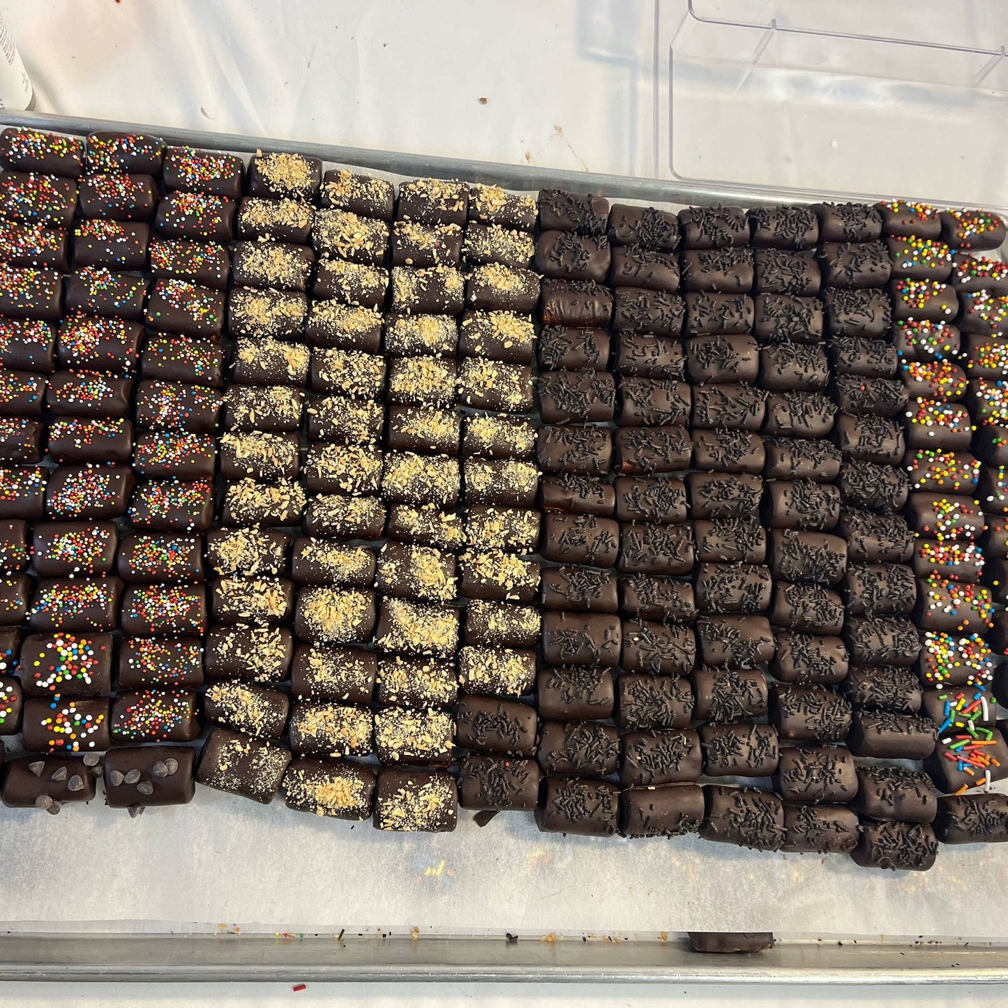 Assorted chocolate-covered logs with toppings from SUPREME - Passover, perfect for gourmet food gift basket collections.