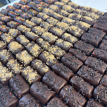 PENULTIMATE - Passover chocolate-covered logs topped with sprinkles and crushed nuts, ideal for festive kosher gift baskets.