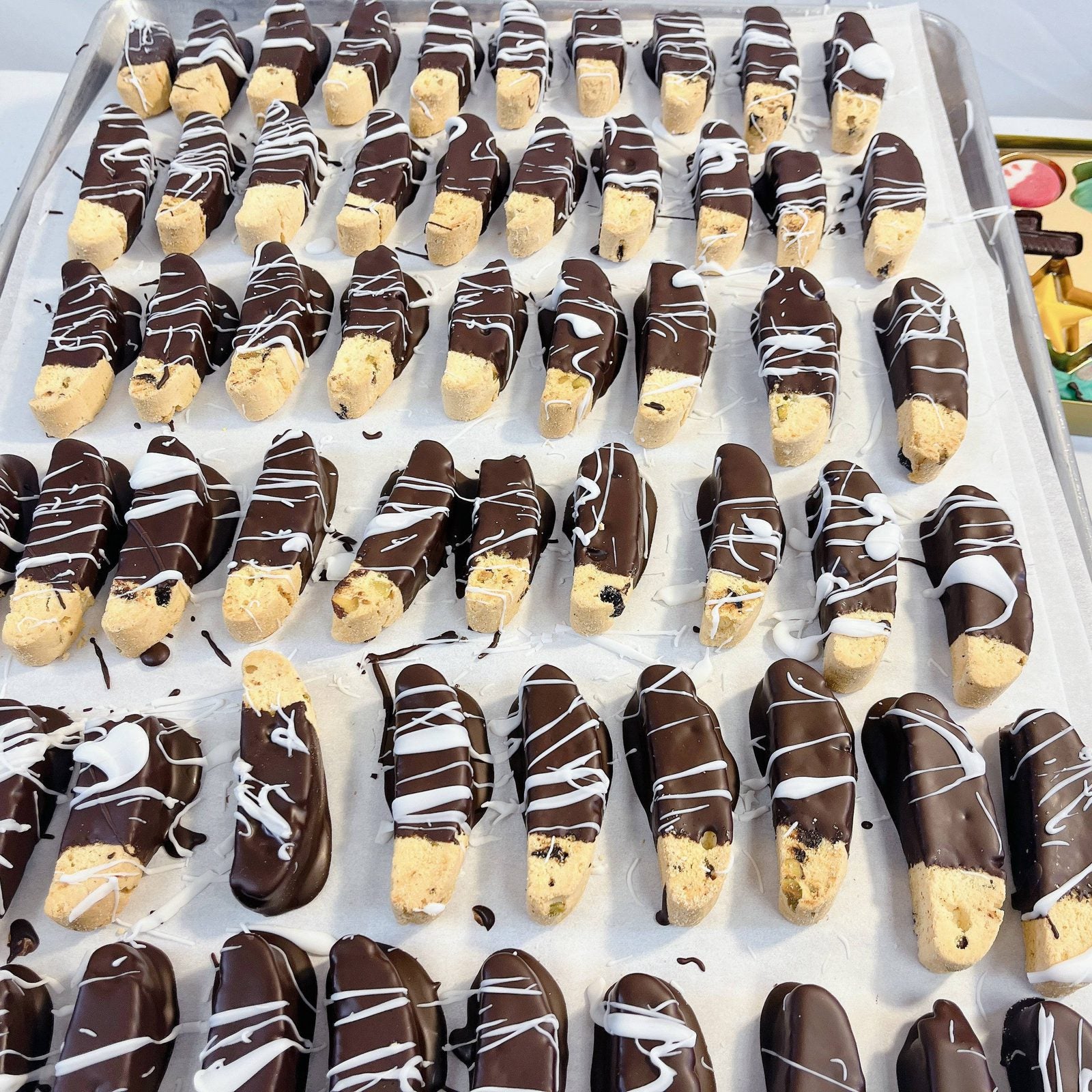 Chocolate-dipped biscotti with white drizzle from SUPREME - Passover, a gourmet addition to premium food gift baskets.