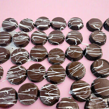 Round chocolate cups with white drizzle from SUPREME - Passover, a decadent treat for luxury food gift baskets.