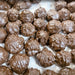 Close-up of chocolate truffles on a white surface
