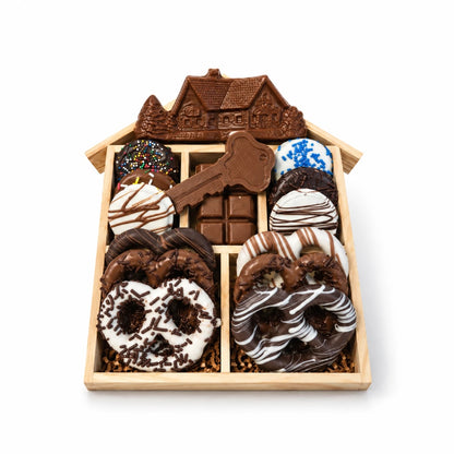 House-shaped wood gift tray with a chocolate house, chocolate key, chocolate-covered pretzels and Oreos