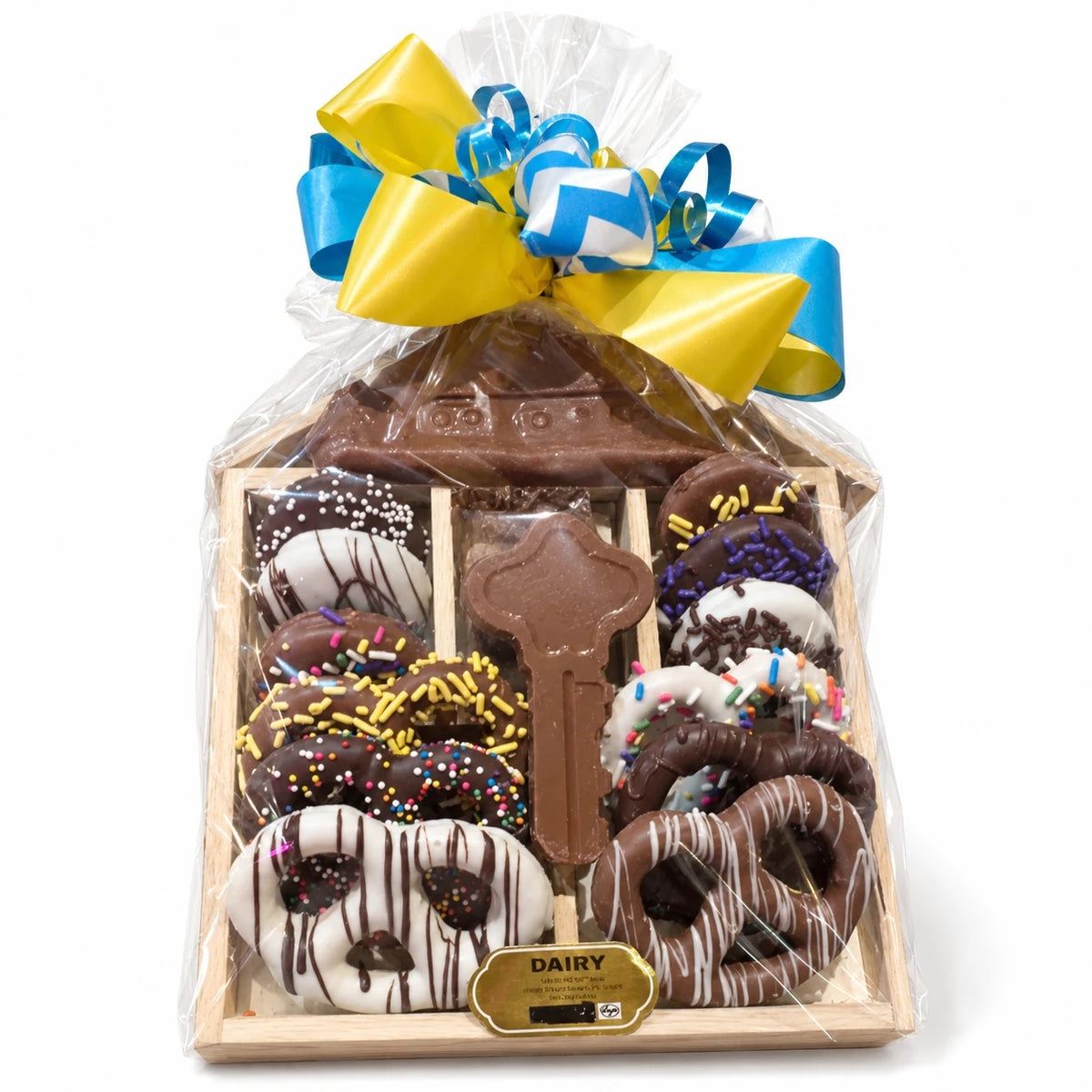 House-shaped wood gift tray with chocolate house, key, pretzels and Oreos, wrapped in cellophane with a blue and yellow bow