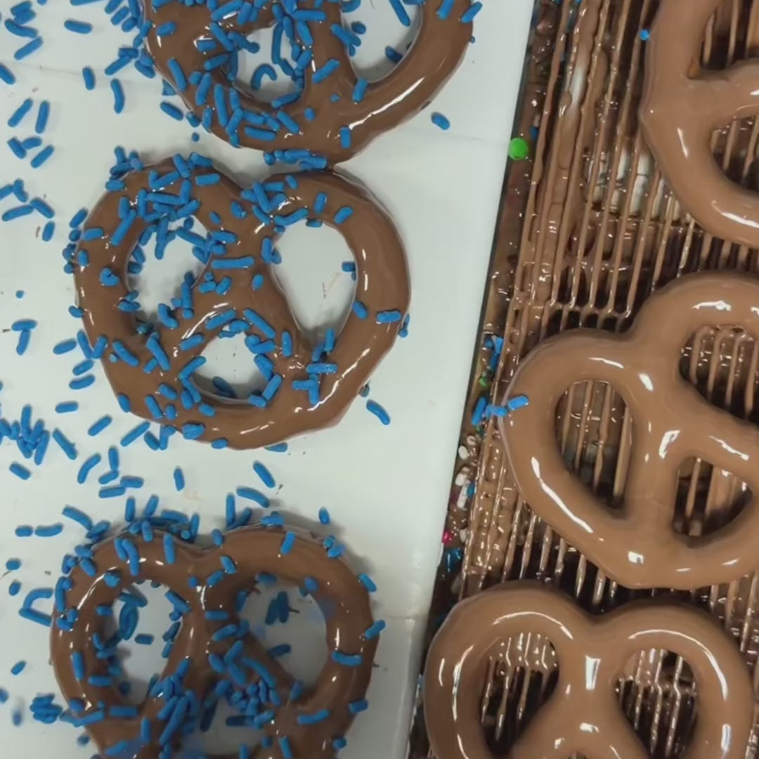 Chocolate dipped pretzels with blue sprinkles