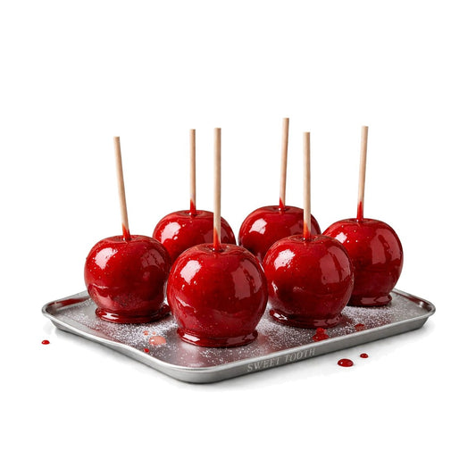 Six classic red candy apples on a tray
