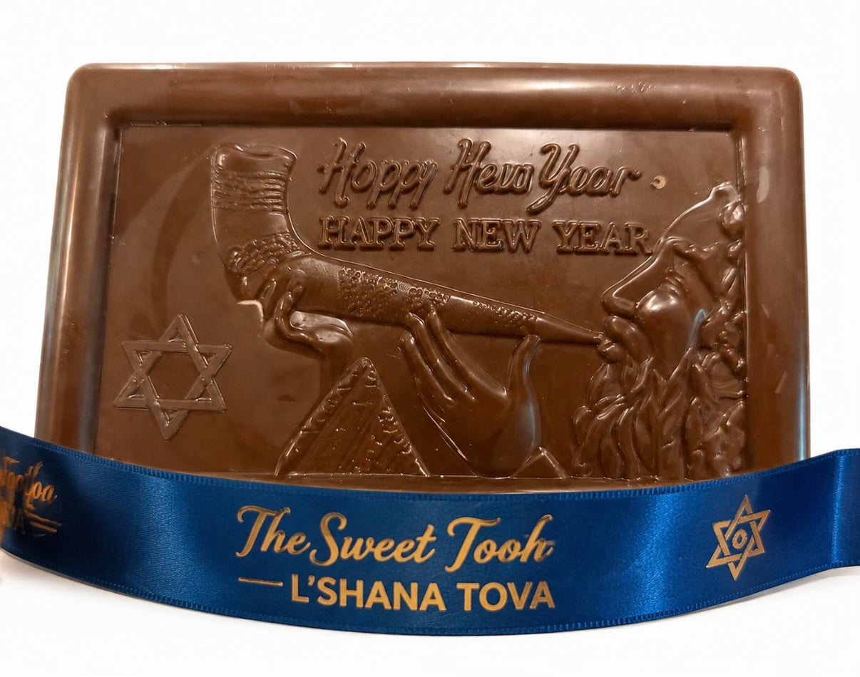 Rosh Hashanah chocolate bar with molded rabbi blowing a shofar, Star of David, and 'Happy New Year' greeting, wrapped with a blue L'Shana Tova ribbon from The Sweet Tooth