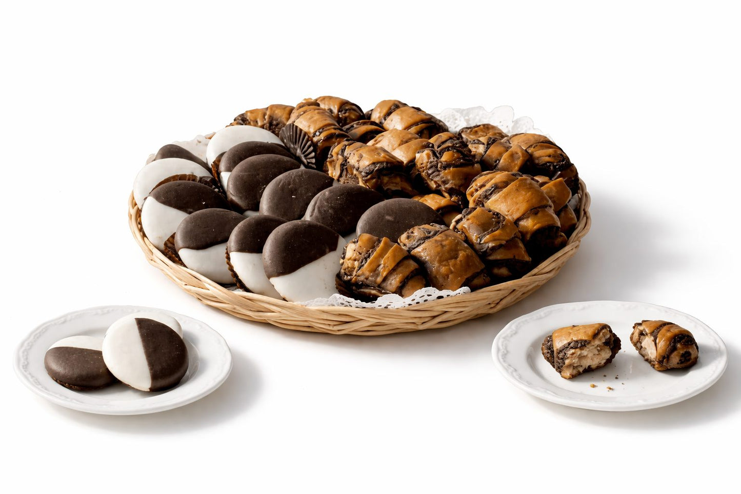 Wicker basket of Sonny's black and white cookies with chocolate rugelach on a white background