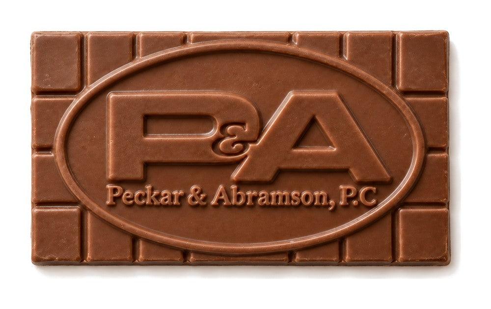 A chocolate bar molded with the P&A company logo